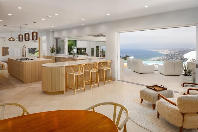 1904 Via Casa Alta, La Jolla, CA 92037 - kitchen featuring light brown cabinetry, modern cabinets, healthy amount of natural light, light countertops, and recessed lighting