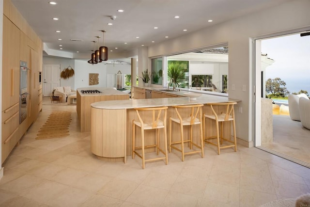 1904 Via Casa Alta, La Jolla, CA 92037 - kitchen with recessed lighting, light countertops, a chandelier, a breakfast bar area, and open floor plan