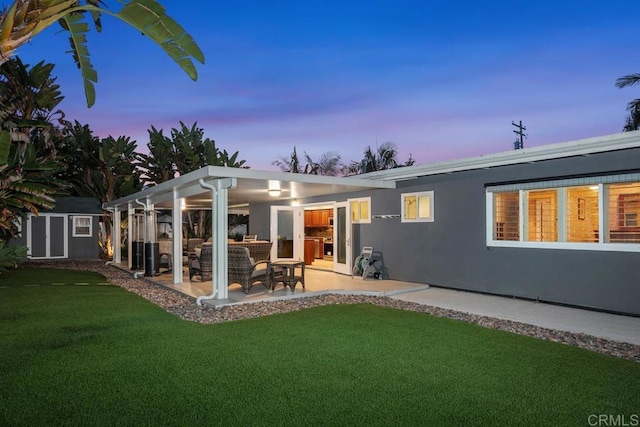 773 Puebla St, Encinitas, CA 92024 - back of house featuring a patio, a yard, a storage unit, an outdoor living space, and stucco siding