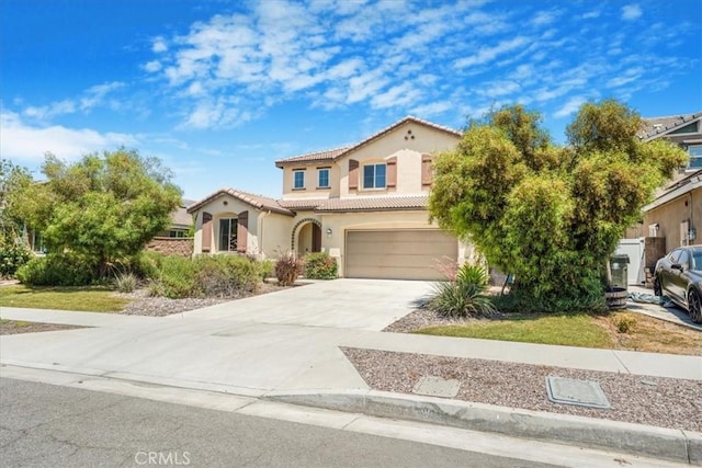 1920 Clementine St, Redlands, CA 92374 - mediterranean / spanish-style home featuring a tile roof, driveway, an attached garage, and stucco siding