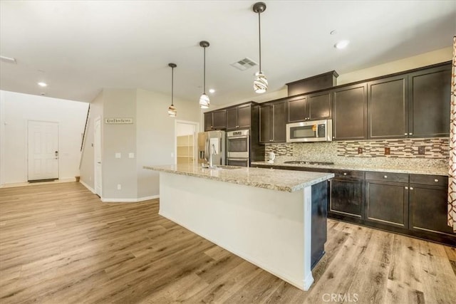 1920 Clementine St, Redlands, CA 92374 - kitchen with stainless steel appliances, light wood-style flooring, dark brown cabinets, and recessed lighting