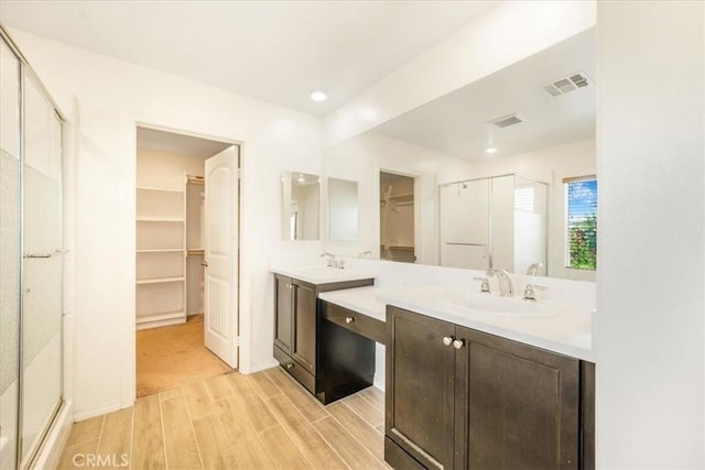 1920 Clementine St, Redlands, CA 92374 - full bathroom featuring a spacious closet, a stall shower, wood finished floors, vanity, and recessed lighting