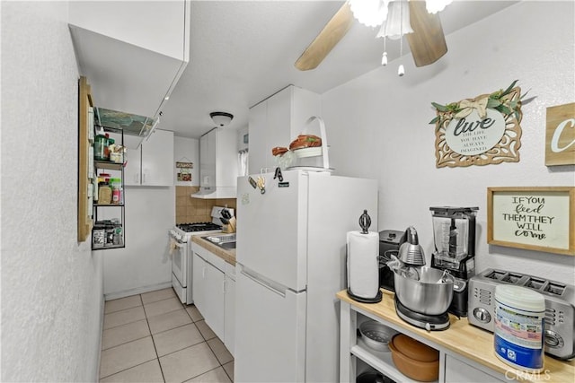 10663 Linden Ave, Bloomington, CA 92316 - kitchen featuring white appliances, light tile patterned floors, white cabinets, tasteful backsplash, and ceiling fan