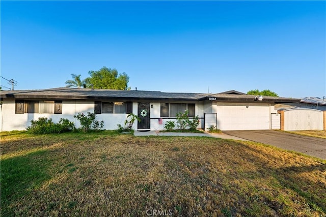 10663 Linden Ave, Bloomington, CA 92316 - single story home featuring a garage, concrete driveway, a front lawn, and stucco siding