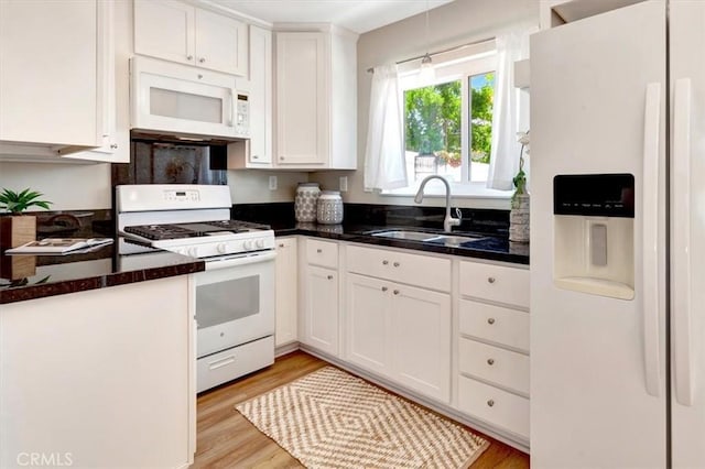 6782 Tahitian Cir, Yorba Linda, CA 92886 - kitchen featuring white appliances, white cabinetry, light wood-type flooring, and hanging light fixtures