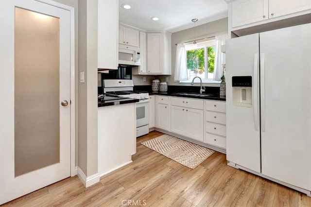 6782 Tahitian Cir, Yorba Linda, CA 92886 - kitchen featuring white appliances, white cabinetry, light wood-type flooring, dark countertops, and recessed lighting