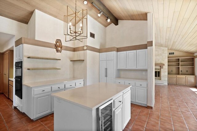 32204 Wiskon Way, Pauma Valley, CA 92061 - kitchen featuring beverage cooler, a wooden ceiling with exposed beams, tile patterned floors, a chandelier, and light countertops