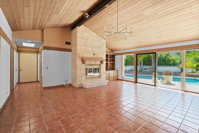 32204 Wiskon Way, Pauma Valley, CA 92061 - unfurnished living room featuring tile patterned floors, a wooden ceiling with exposed beams, built in shelves, a stone fireplace, and high vaulted ceiling