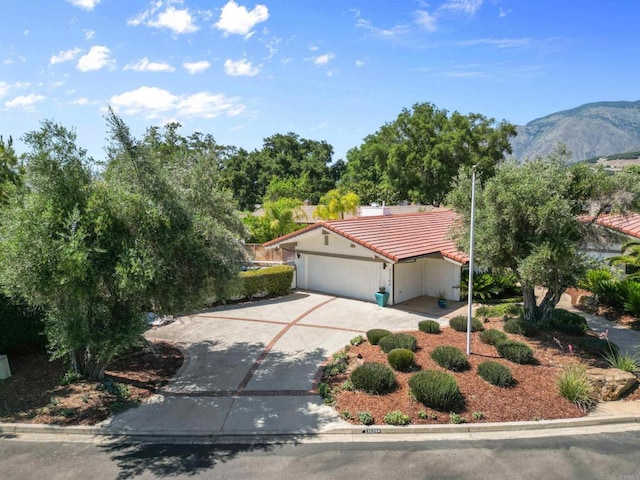 32204 Wiskon Way, Pauma Valley, CA 92061 - mediterranean / spanish home featuring a tiled roof, driveway, an attached garage, a mountain view, and stucco siding