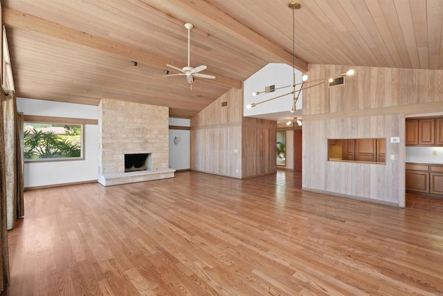32204 Wiskon Way, Pauma Valley, CA 92061 - unfurnished living room with ceiling fan, light wood finished floors, high vaulted ceiling, a stone fireplace, and a wooden ceiling with exposed beams
