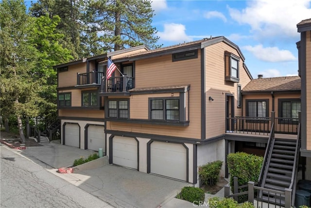 4 Village Unit 2, Lake Arrowhead, CA 92352 - view of front of house featuring stairway, an attached garage, and concrete driveway