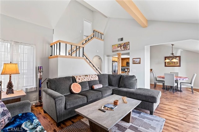 4 Village Unit 2, Lake Arrowhead, CA 92352 - living area featuring wood finished floors, stairway, beam ceiling, and high vaulted ceiling