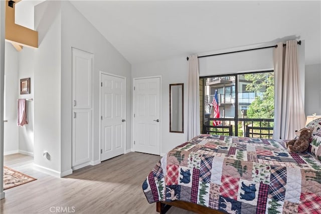 4 Village Unit 2, Lake Arrowhead, CA 92352 - bedroom featuring access to exterior, lofted ceiling, and light wood-style flooring