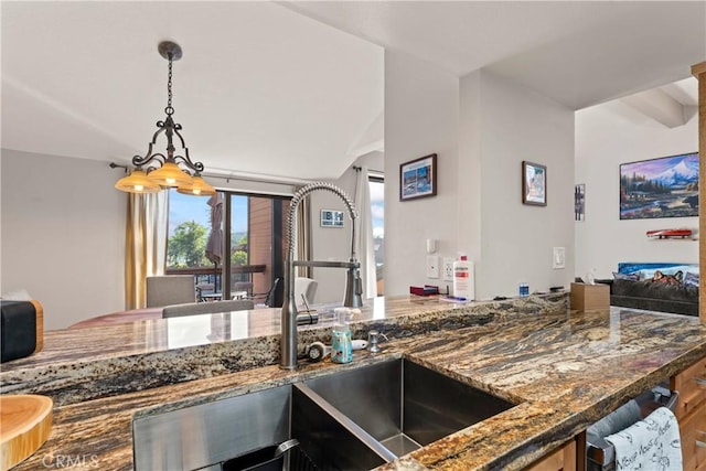 4 Village Unit 2, Lake Arrowhead, CA 92352 - kitchen featuring dark stone counters, pendant lighting, and lofted ceiling