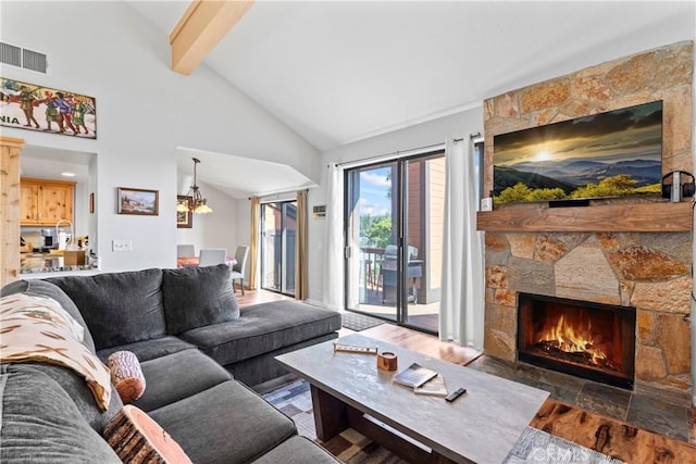 4 Village Unit 2, Lake Arrowhead, CA 92352 - living area with beamed ceiling, a stone fireplace, wood finished floors, and high vaulted ceiling