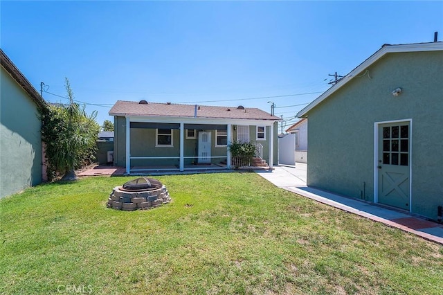 4903 Brayton Ave, Long Beach, CA 90807 - rear view of property with a fire pit, stucco siding, and a lawn