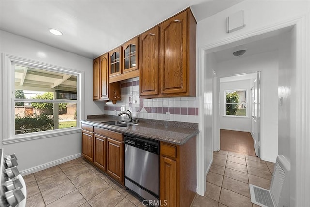 4903 Brayton Ave, Long Beach, CA 90807 - kitchen with dishwasher, dark countertops, brown cabinetry, and decorative backsplash