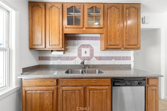 4903 Brayton Ave, Long Beach, CA 90807 - kitchen with dishwasher, brown cabinets, decorative backsplash, glass insert cabinets, and light stone counters