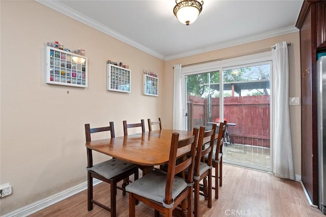 17061 Roscoe Blvd Unit 6, Northridge, CA 91325 - dining space featuring light wood-style floors and ornamental molding