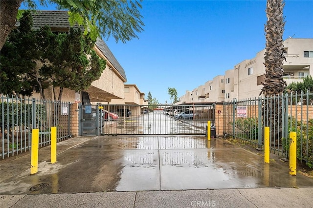 17061 Roscoe Blvd Unit 6, Northridge, CA 91325 - view of home's community with a gate, a residential view, and uncovered parking