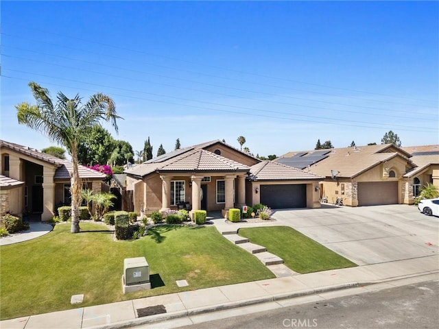 9504 Whitman Ave, Bakersfield, CA 93311 - view of front of home with an attached garage, stucco siding, a tiled roof, a front lawn, and driveway