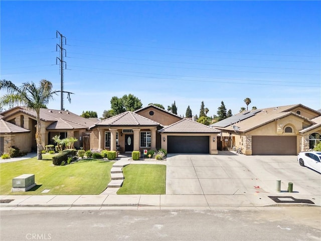 9504 Whitman Ave, Bakersfield, CA 93311 - view of front of home with a garage, concrete driveway, a tiled roof, stucco siding, and a front yard