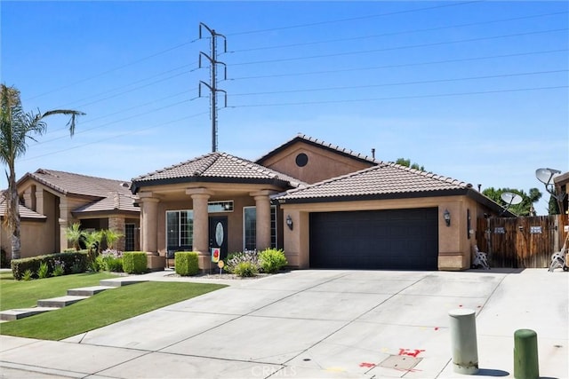 9504 Whitman Ave, Bakersfield, CA 93311 - mediterranean / spanish-style house with an attached garage, stucco siding, driveway, and a tiled roof