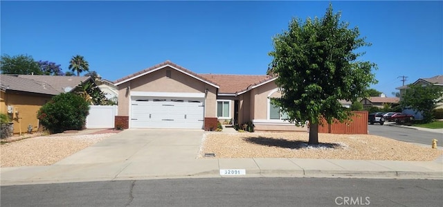 32091 Bayberry Rd, Wildomar, CA 92595 - ranch-style home with stucco siding, concrete driveway, a garage, and a tile roof