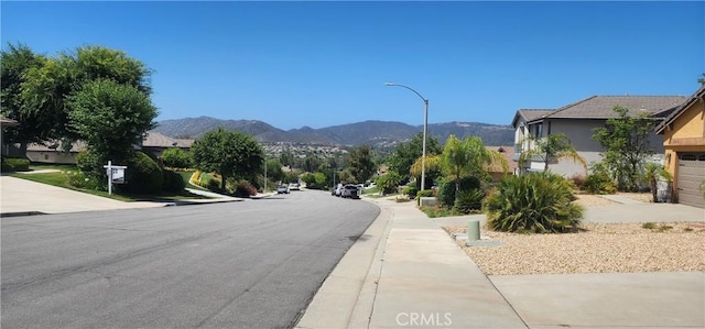 32091 Bayberry Rd, Wildomar, CA 92595 - view of asphalt street featuring street lights, a mountain view, and sidewalks