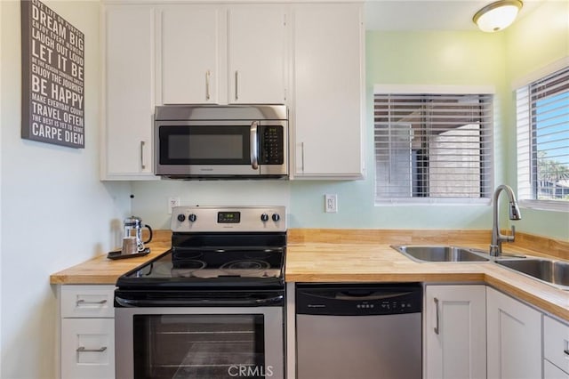 460 Golden Ave Unit 434, Long Beach, CA 90802 - kitchen with appliances with stainless steel finishes, wood counters, and white cabinets