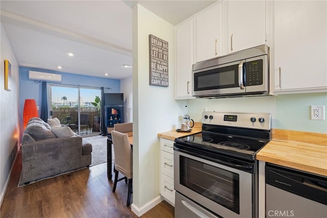 460 Golden Ave Unit 434, Long Beach, CA 90802 - kitchen featuring appliances with stainless steel finishes, wooden counters, an AC wall unit, dark wood finished floors, and recessed lighting