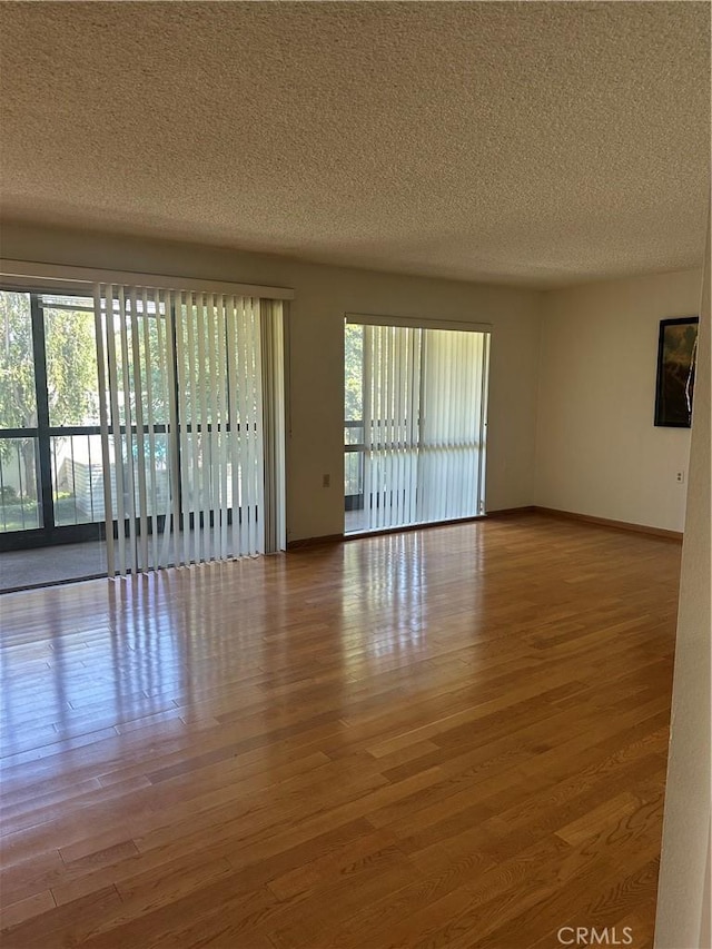 967 Calle Aragon Unit B, Laguna Woods, CA 92637 - spare room featuring a textured ceiling and wood finished floors