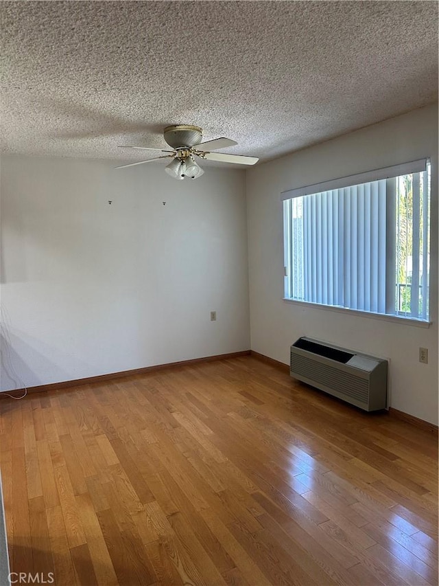 967 Calle Aragon Unit B, Laguna Woods, CA 92637 - unfurnished room with wood finished floors, a ceiling fan, and a textured ceiling