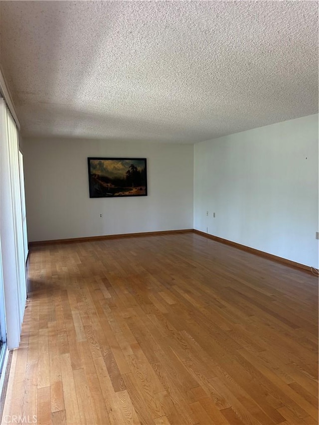 967 Calle Aragon Unit B, Laguna Woods, CA 92637 - spare room featuring a textured ceiling and light wood-type flooring