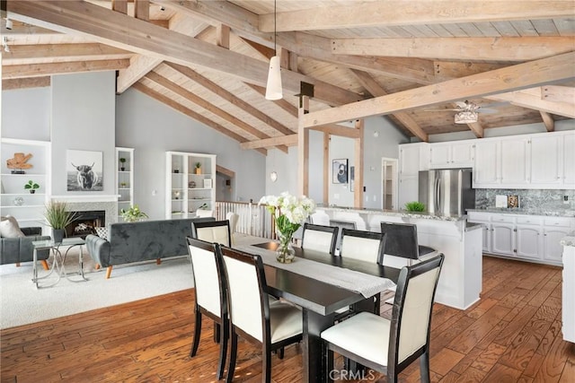 626 Arenas St Unit A, La Jolla, CA 92037 - dining area featuring dark wood finished floors, high vaulted ceiling, a fireplace, and a wooden ceiling with exposed beams