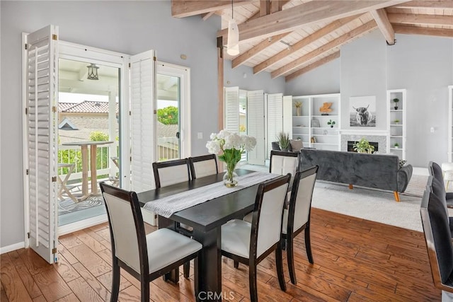 626 Arenas St Unit A, La Jolla, CA 92037 - dining space featuring hardwood / wood-style floors, high vaulted ceiling, a fireplace, built in features, and a wood ceiling with exposed beams