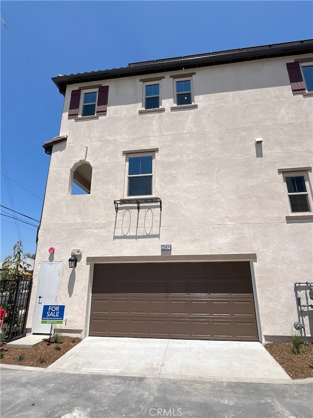 12247 Elliott Ave Unit G, El Monte, CA 91732 - back of house featuring a garage and stucco siding