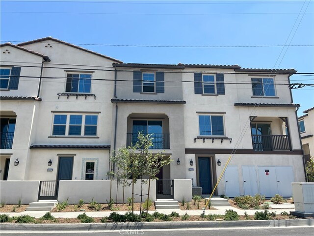 12247 Elliott Ave Unit G, El Monte, CA 91732 - townhome / multi-family property featuring stucco siding, a tiled roof, and a gate