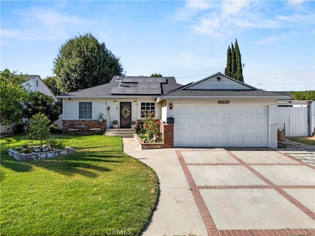 18229 Strathern St, Reseda, CA 91335 - single story home featuring brick siding, a front yard, concrete driveway, an attached garage, and solar panels