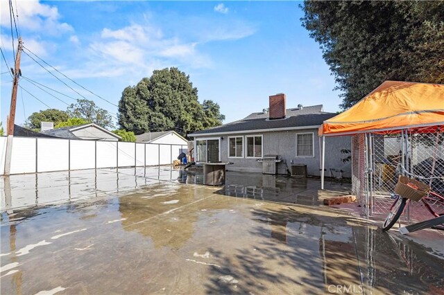 18229 Strathern St, Reseda, CA 91335 - back of house featuring a fenced backyard, a chimney, and a patio