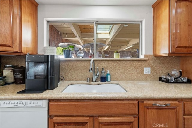 18229 Strathern St, Reseda, CA 91335 - kitchen featuring dishwasher, brown cabinetry, light countertops, and backsplash