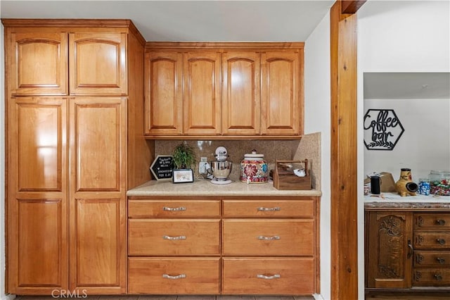 18229 Strathern St, Reseda, CA 91335 - kitchen featuring backsplash, light countertops, and brown cabinetry
