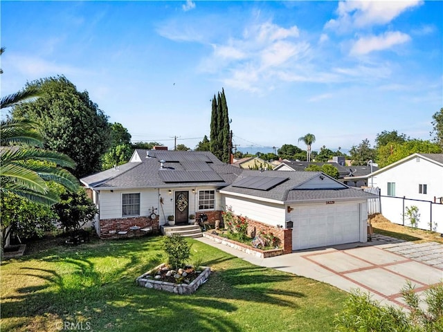 18229 Strathern St, Reseda, CA 91335 - ranch-style home with brick siding, a garage, roof mounted solar panels, driveway, and roof with shingles