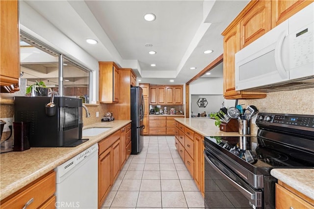 18229 Strathern St, Reseda, CA 91335 - kitchen featuring white appliances, tasteful backsplash, light countertops, light tile patterned floors, and recessed lighting