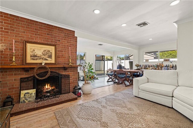 18229 Strathern St, Reseda, CA 91335 - living area with crown molding, a brick fireplace, wood finished floors, and recessed lighting