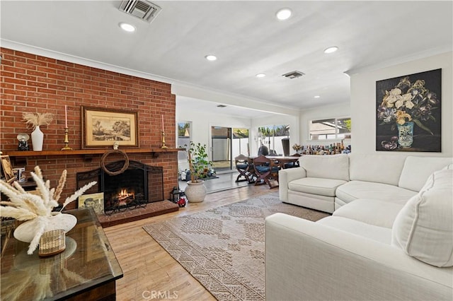 18229 Strathern St, Reseda, CA 91335 - living room featuring ornamental molding, wood finished floors, a brick fireplace, and recessed lighting