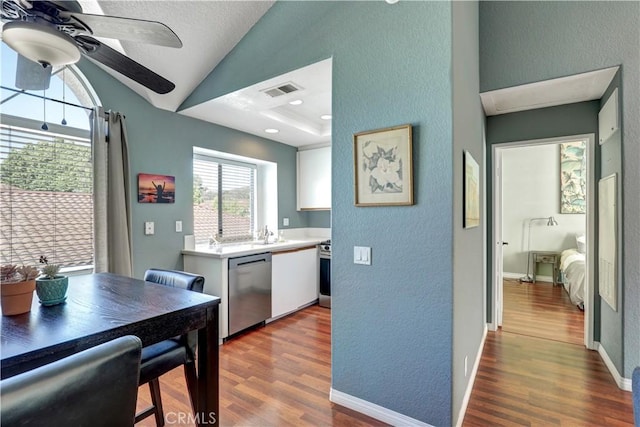 94 Cinnamon Teal, Aliso Viejo, CA 92656 - kitchen featuring appliances with stainless steel finishes, wood finished floors, light countertops, a textured wall, and lofted ceiling