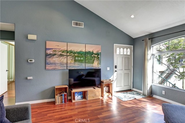 94 Cinnamon Teal, Aliso Viejo, CA 92656 - living area with wood finished floors, a textured wall, and high vaulted ceiling