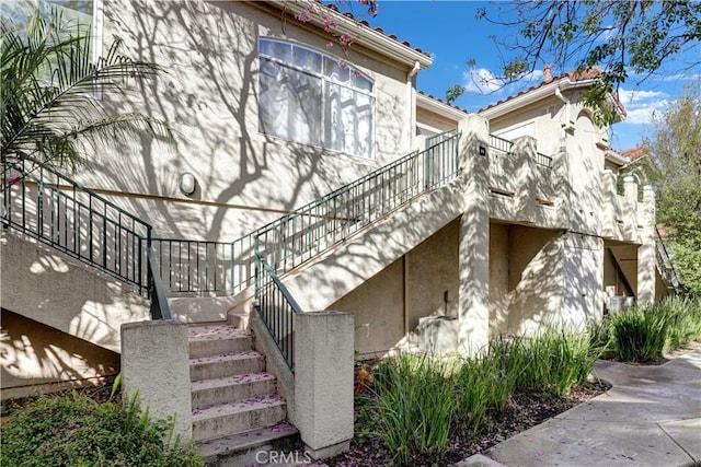 94 Cinnamon Teal, Aliso Viejo, CA 92656 - view of side of property with stairs and stucco siding