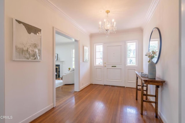 653 Chaucer Rd, San Marino, CA 91108 - foyer featuring a chandelier, wood finished floors, healthy amount of natural light, a fireplace, and ornamental molding